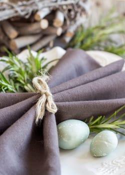 Easter table setting with eggs and rosemary
