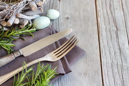 Easter table setting with eggs and rosemary