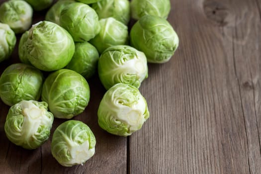 Brussels sprouts in a bowl on an old wooden table