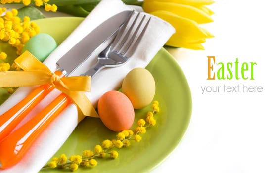 Easter table setting with yellow flowers and eggs