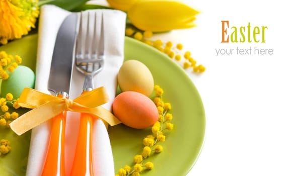 Easter table setting with yellow tulips and mimosa
