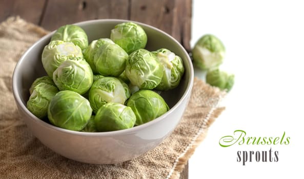 Brussels sprouts in a bowl on an old wooden table