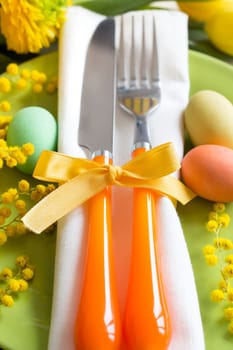 Easter table setting with yellow flowers and eggs