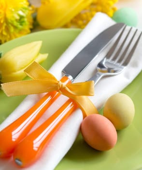 Easter table setting with yellow tulips and eggs