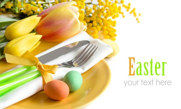 Easter table setting with yellow tulips and mimosa