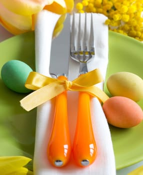 Easter table setting with yellow flowers and eggs