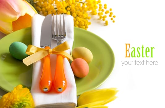 Easter table setting with yellow flowers and eggs