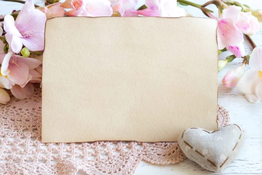 Shabby spring paper background with freesia flowers and heart