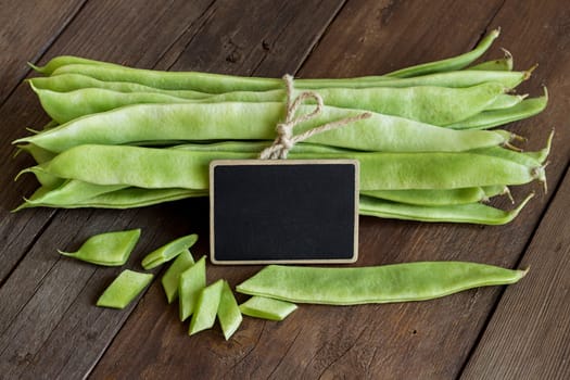 Piattoni green beans with small chalkboard on the old wooden table