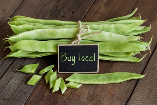 Piattoni green beans with small chalkboard on the old wooden table