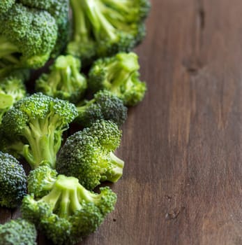 Fresh broccoli on old wooden table close up