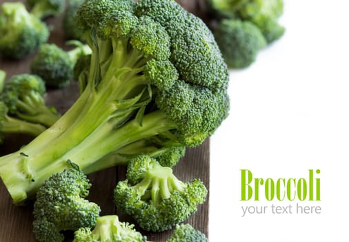 Fresh broccoli on old wooden table close up
