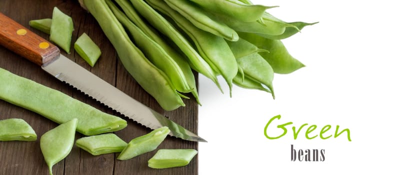 Piattoni green beans with knife on the old wooden table