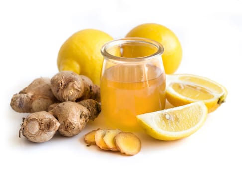 Honey in a jar, lemon and ginger isolated on white