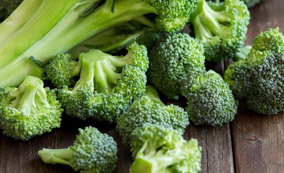Fresh broccoli on old wooden table close up