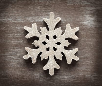 Wooden snowflake on a shabby chic wooden table