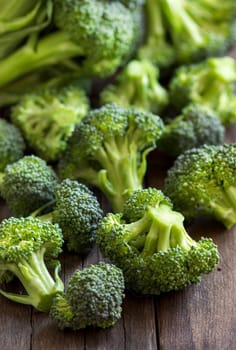 Fresh broccoli on old wooden table close up