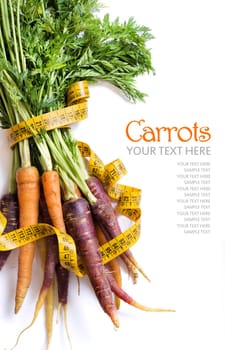 Fresh organic rainbow carrots and yellow measuring type