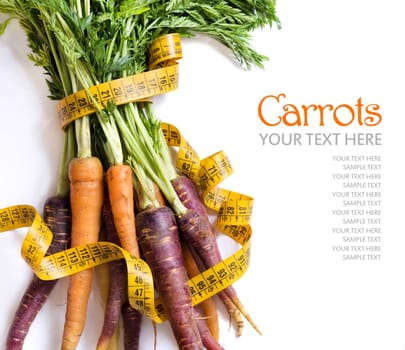 Fresh organic rainbow carrots and yellow measuring type