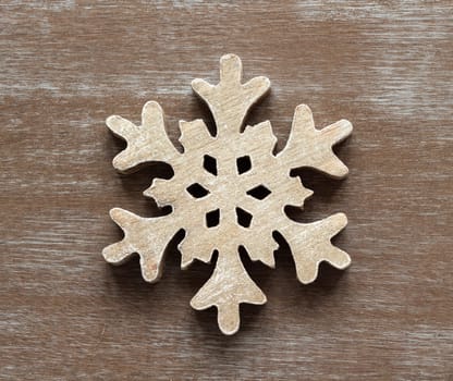 Wooden snowflake on a shabby chic wooden table