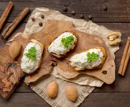 Toasted bread with a salted codfish mousse on wooden cutting board