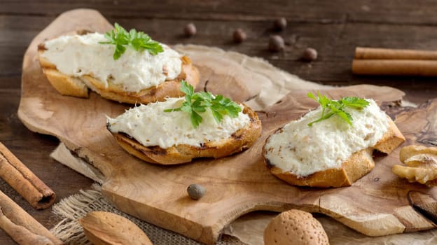 Toasted bread with a salted codfish mousse on wooden cutting board
