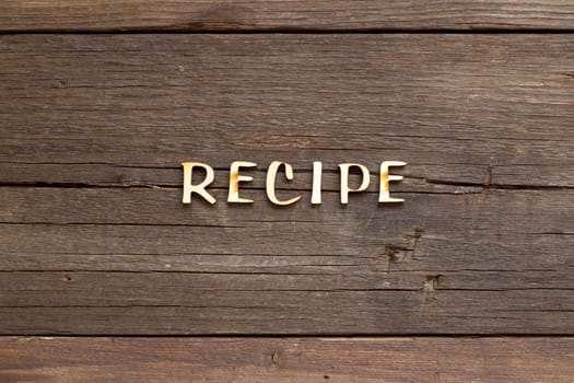 The word of Recipe on a wooden background