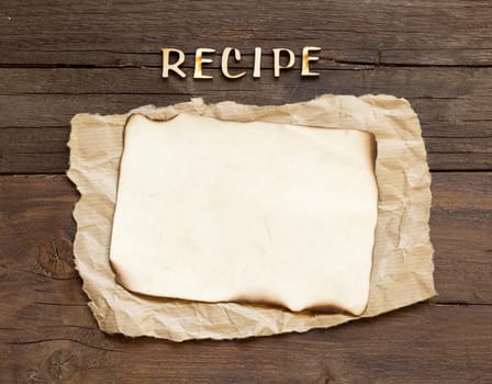 Recipes word with paper on wooden background