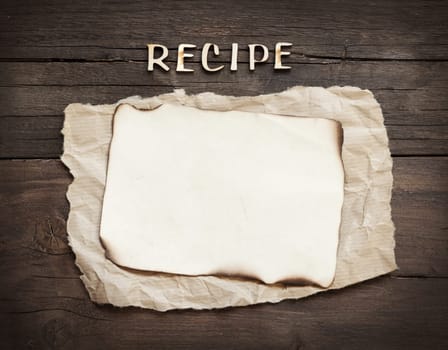 Recipes word with paper on wooden background