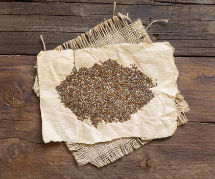 Pile of chia seeds on a rustic background