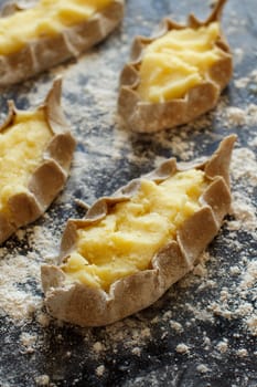 Traditional karelian pasties with potatoes before oven