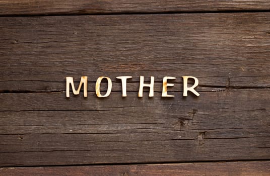 The word of Mother on a wooden background