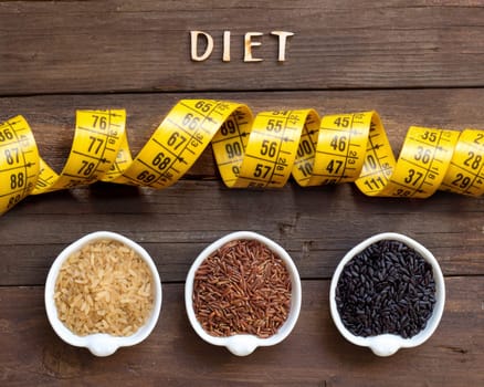 Variety of rice and word Diet on a wooden background