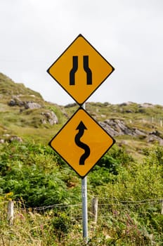 Signs of winding road and bottleneck on a Irish road