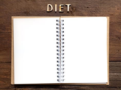 The word of Diet and notebook on wooden background