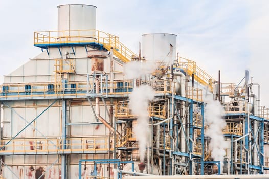 Chemical plant of a factory. Smokestacks ,pipes and tank.