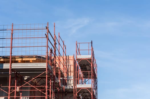 House under construction with the scaffolding for bricklayers