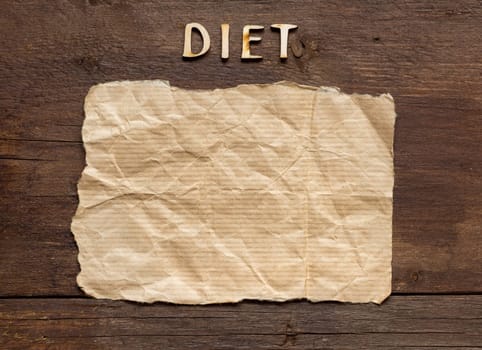 The word of Diet and paper on wooden background
