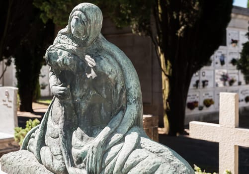 More than 100 years old statue. Cemetery located in North Italy.