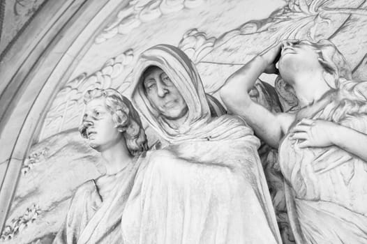 More than 100 years old statue. Cemetery located in North Italy. Black and white
