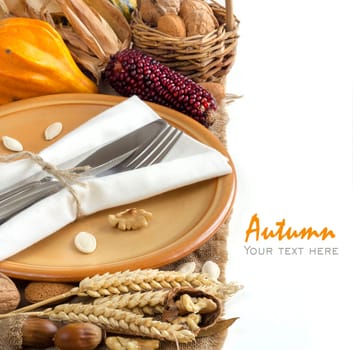 Autumn table setting with corn, nuts and pumpkins