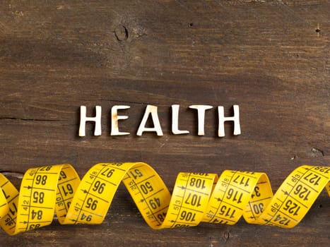 The word of Health on wood and measuring type on wooden background