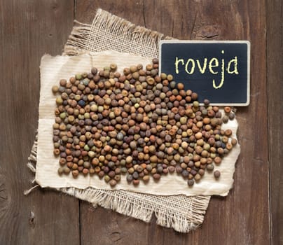 Raw organic roveja beans on a wooden table