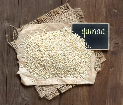 Organic quinoa with a small chalkboard on a wooden table