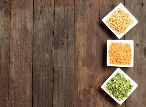 Legumes in bowls on a wooden table