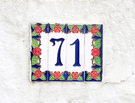 Ceramic Number 71 on the white wall