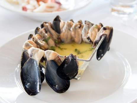 Raw Mussels with lemon sauce in a bowl