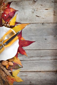 retro autumn table setting with leaves, nuts and acorns
