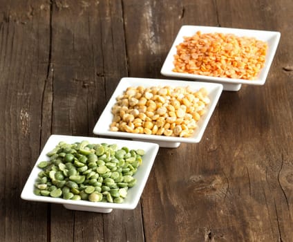 Legumes in bowls on a wooden table