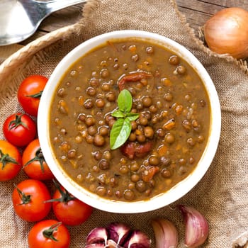 Cooked roveja stew with cherry tomatoes, garlic and onion